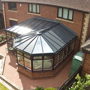 A beautiful P-shaped conservatory attached to a traditional Dorset home, seamlessly blending with the garden.